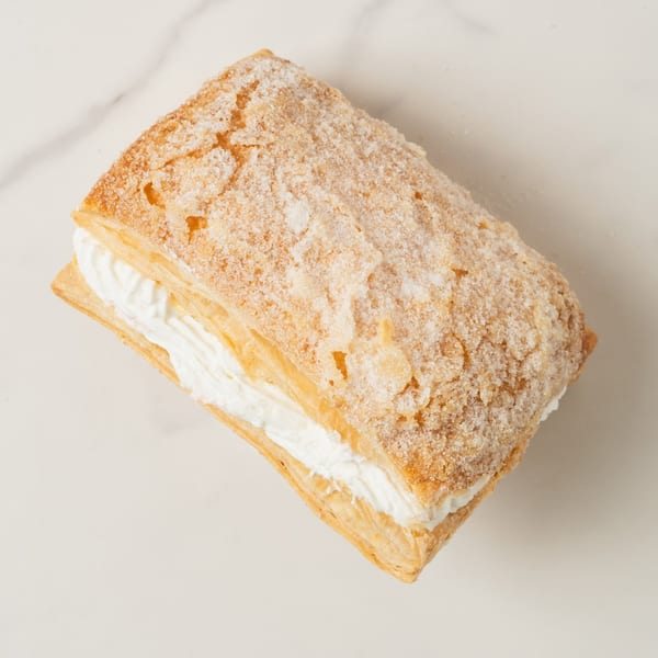 Elmwood Pastry Shop's rectangular pastry with flaky layers, white cream filling, and a sugary top.