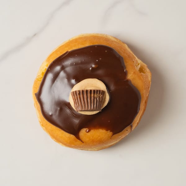 A peanut butter cup donut from Elmwood Pastry Shop, topped with chocolate frosting and a mini Reese's.